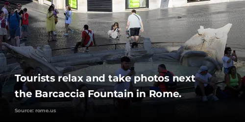 Tourists relax and take photos next to the Barcaccia Fountain in Rome.