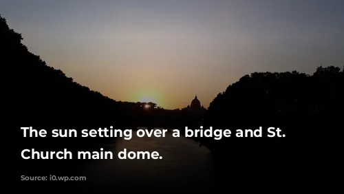 The sun setting over a bridge and St. Peter's Church main dome.