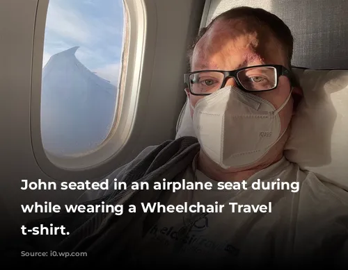 John seated in an airplane seat during flight while wearing a Wheelchair Travel logo t-shirt.