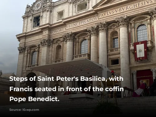 Steps of Saint Peter's Basilica, with Pope Francis seated in front of the coffin of Pope Benedict.