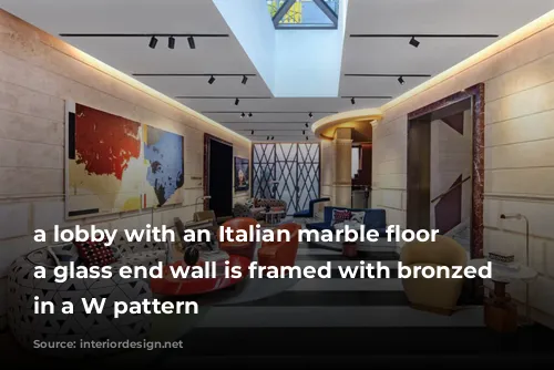 a lobby with an Italian marble floor and a glass end wall is framed with bronzed steel in a W pattern