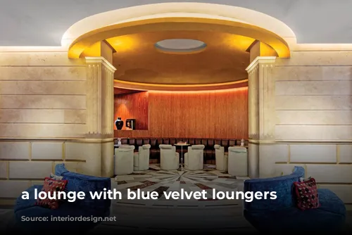 a lounge with blue velvet loungers