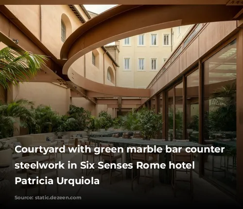 Courtyard with green marble bar counter below steelwork in Six Senses Rome hotel by Patricia Urquiola