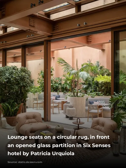 Lounge seats on a circular rug, in front of an opened glass partition in Six Senses Rome hotel by Patricia Urquiola