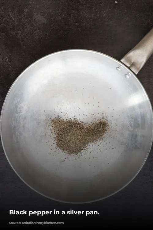 Black pepper in a silver pan.