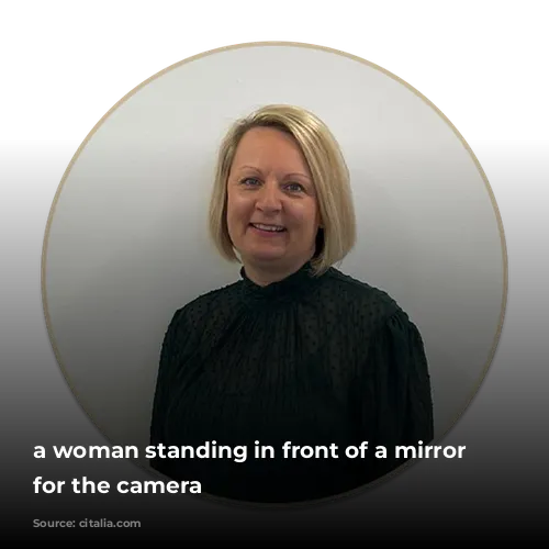 a woman standing in front of a mirror posing for the camera