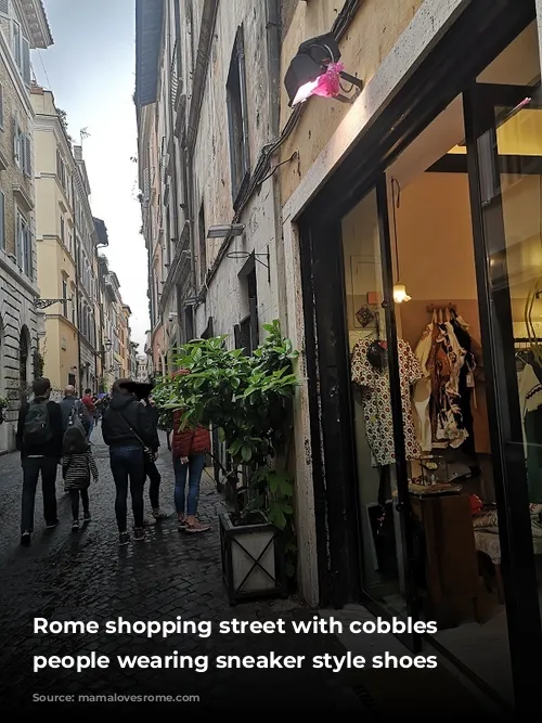 Rome shopping street with cobbles and people wearing sneaker style shoes