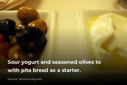 Sour yogurt and seasoned olives to eat with pita bread as a starter.