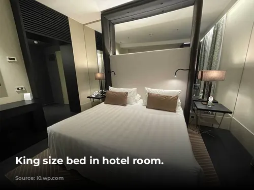 King size bed in hotel room.