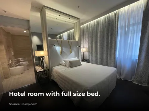 Hotel room with full size bed.