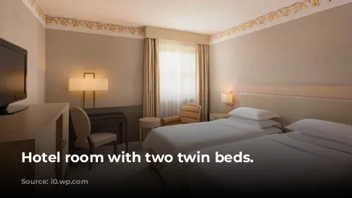 Hotel room with two twin beds.