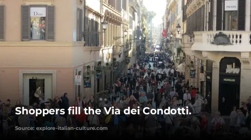 Shoppers fill the Via dei Condotti.