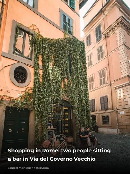 Shopping in Rome: two people sitting outside a bar in Via del Governo Vecchio