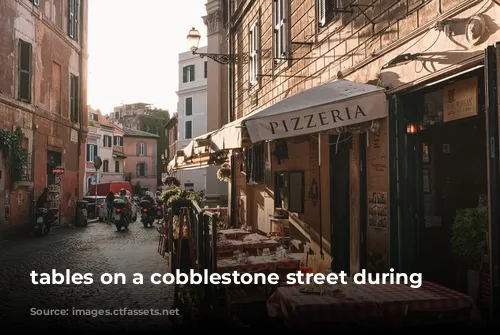 tables on a cobblestone street during daytime