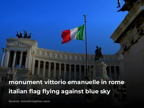 monument vittorio emanuelle in rome with italian flag flying against blue sky