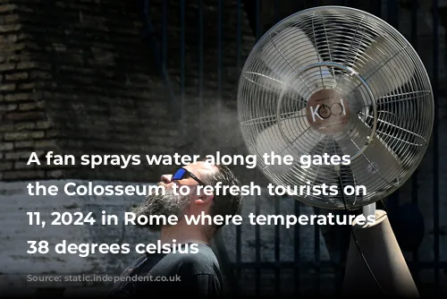 A fan sprays water along the gates of the Colosseum to refresh tourists on July 11, 2024 in Rome where temperatures reach 38 degrees celsius