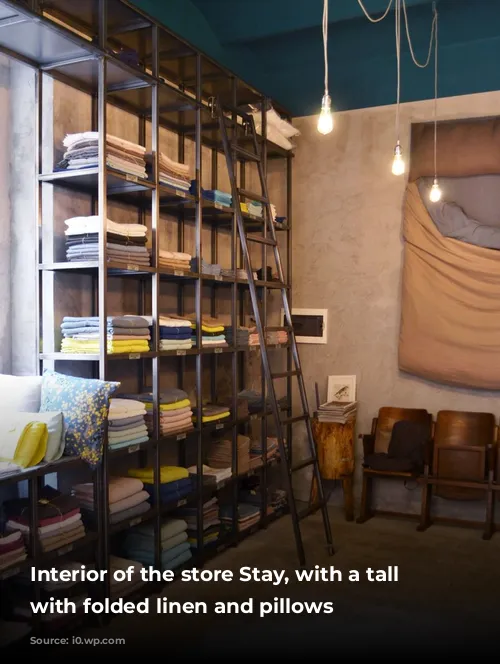 Interior of the store Stay, with a tall cabinet with folded linen and pillows 