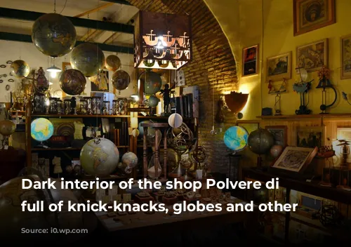 Dark interior of the shop Polvere di Tempo full of knick-knacks, globes and other items. 