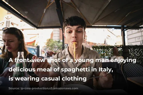 A front-view shot of a young man enjoying a delicious meal of spaghetti in Italy, he is wearing casual clothing